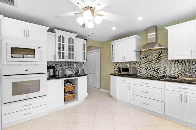 10421 NW 21st St, Pembroke Pines, FL 33026 - kitchen featuring white appliances, wall chimney exhaust hood, a ceiling fan, dark countertops, and backsplash