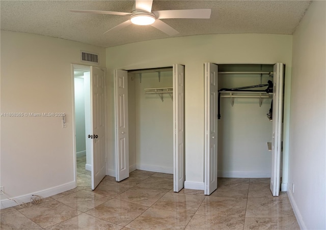 3090 Holiday Springs Blvd Unit 305, Margate, FL 33063 - unfurnished bedroom with two closets, a textured ceiling, and a ceiling fan