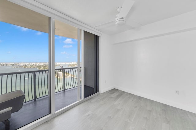 1750 N Bayshore Dr Unit 4801, Miami, FL 33132 - spare room featuring a water view, floor to ceiling windows, wood finished floors, ceiling fan, and baseboards