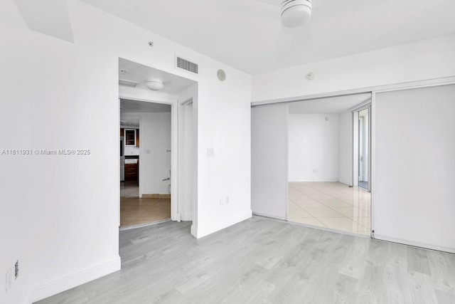 1750 N Bayshore Dr Unit 4801, Miami, FL 33132 - unfurnished bedroom with wood finished floors, a closet, and baseboards