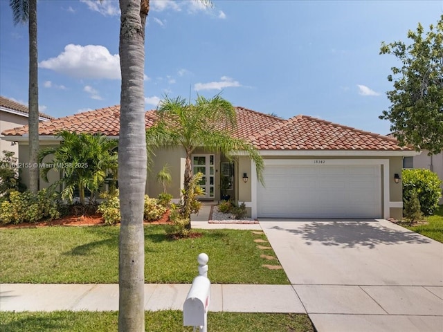 18342 NW 11th St, Pembroke Pines, FL 33029 - mediterranean / spanish home with an attached garage, a tile roof, a front yard, stucco siding, and concrete driveway