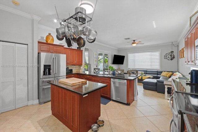 18342 NW 11th St, Pembroke Pines, FL 33029 - kitchen with stainless steel appliances, a peninsula, open floor plan, crown molding, and light tile patterned floors