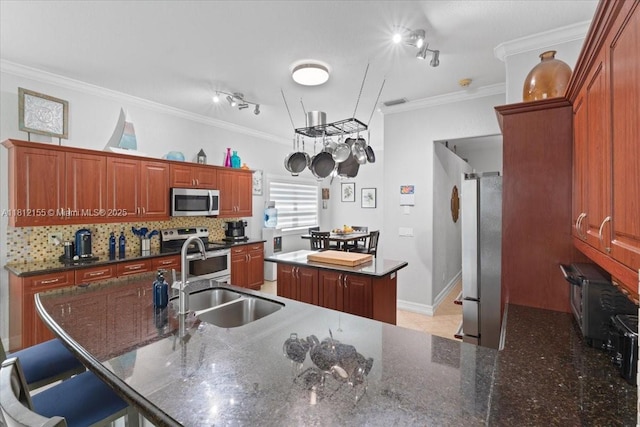 18342 NW 11th St, Pembroke Pines, FL 33029 - kitchen featuring appliances with stainless steel finishes, a sink, a center island, ornamental molding, and tasteful backsplash
