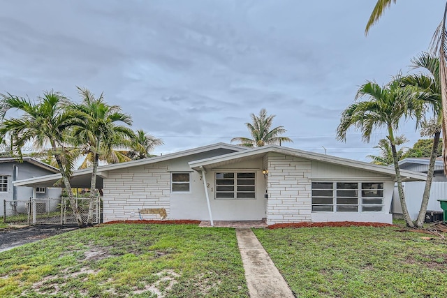 7521 Granada Blvd, Miramar, FL 33023 - view of front of home featuring a gate and stone siding