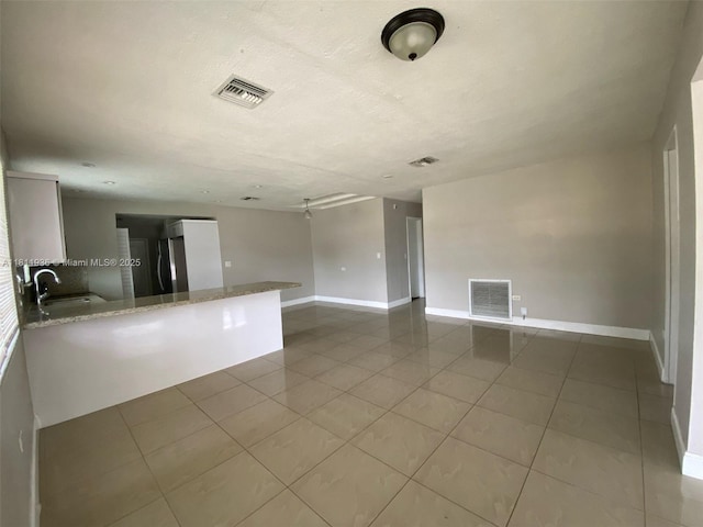 7521 Granada Blvd, Miramar, FL 33023 - unfurnished living room with a sink, tile patterned floors, and baseboards