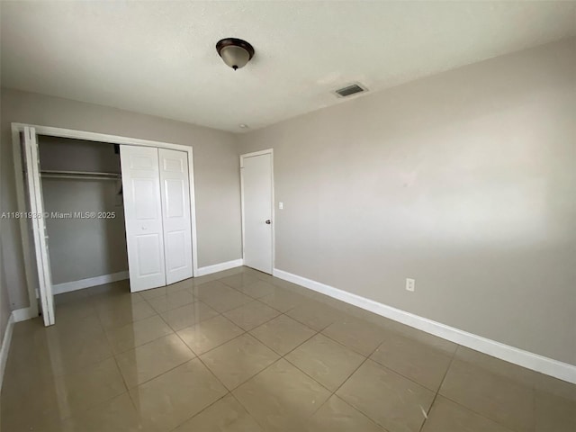 7521 Granada Blvd, Miramar, FL 33023 - unfurnished bedroom with baseboards, a closet, and tile patterned floors