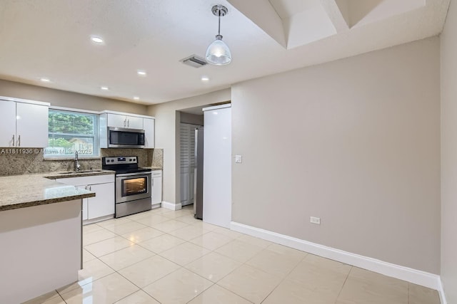 7521 Granada Blvd, Miramar, FL 33023 - kitchen featuring appliances with stainless steel finishes, a sink, white cabinets, backsplash, and recessed lighting