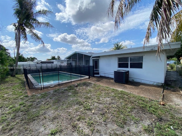 7521 Granada Blvd, Miramar, FL 33023 - rear view of property with cooling unit, a fenced backyard, and a sunroom