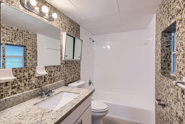 7521 Granada Blvd, Miramar, FL 33023 - bathroom featuring tile walls, toilet, bathtub / shower combination, vanity, and a drop ceiling