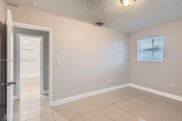 7521 Granada Blvd, Miramar, FL 33023 - unfurnished room featuring a textured ceiling, light tile patterned floors, and baseboards
