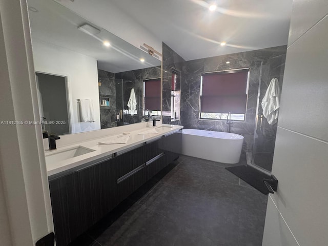 10003 NW 89th Ter, Doral, FL 33178 - bathroom featuring a soaking tub, double vanity, a walk in shower, tile walls, and tile patterned floors