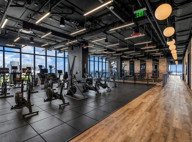 398 NE 5th St Unit 2704, Miami, FL 33132 - exercise room with wood finished floors and a wall of windows