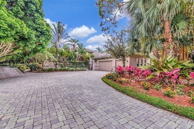 8244 Lakeview Dr, West Palm Beach, FL 33412 - exterior space with decorative driveway, a garage, and stucco siding