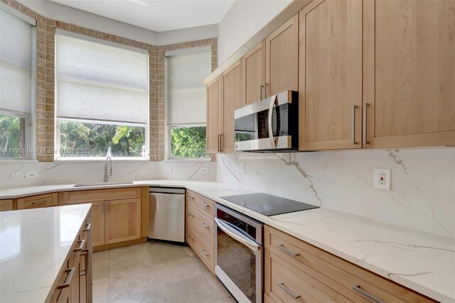 8244 Lakeview Dr, West Palm Beach, FL 33412 - kitchen featuring appliances with stainless steel finishes, a sink, light brown cabinetry, and backsplash