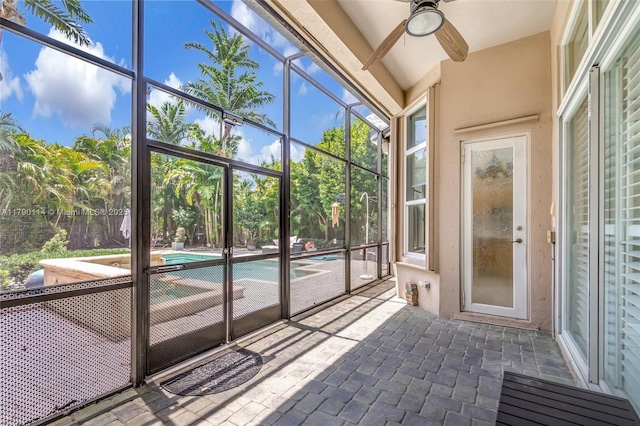 8244 Lakeview Dr, West Palm Beach, FL 33412 - unfurnished sunroom featuring a ceiling fan and view of wooded area