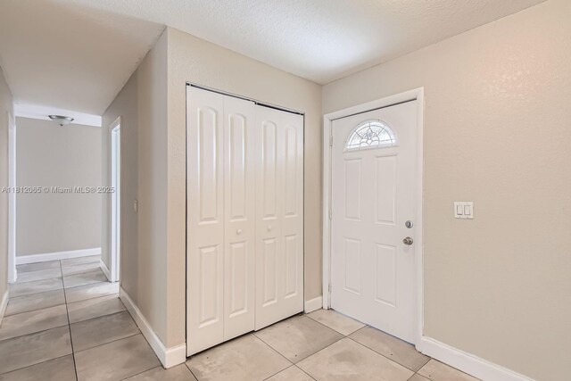 9353 SW 1st Pl, Boca Raton, FL 33428 - entryway with light tile patterned floors and baseboards