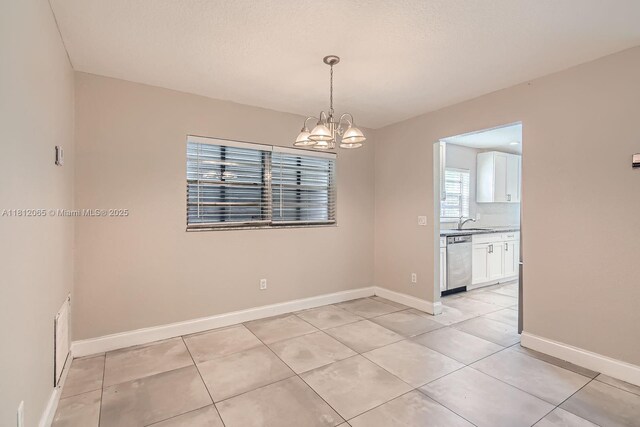 9353 SW 1st Pl, Boca Raton, FL 33428 - unfurnished room with a chandelier, baseboards, light tile patterned floors, and a sink