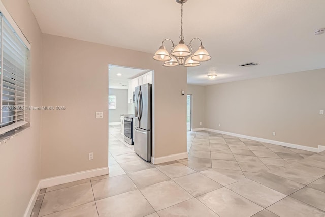9353 SW 1st Pl, Boca Raton, FL 33428 - spare room with a chandelier, light tile patterned floors, baseboards, and a smoke detector
