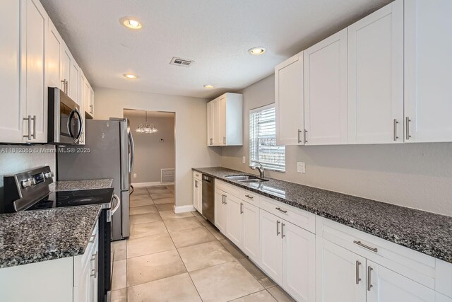 9353 SW 1st Pl, Boca Raton, FL 33428 - kitchen featuring stainless steel appliances, a sink, white cabinets, a chandelier, and recessed lighting