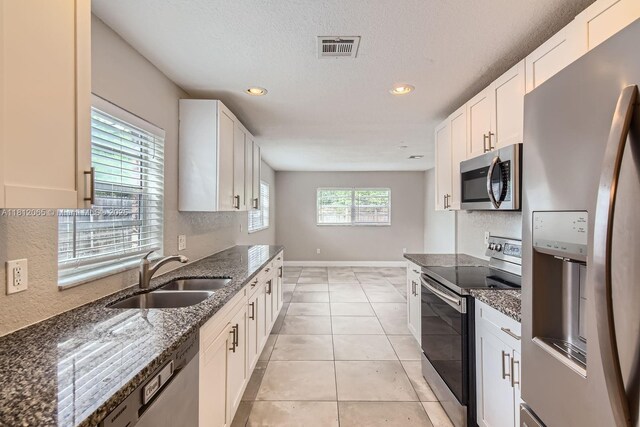 9353 SW 1st Pl, Boca Raton, FL 33428 - kitchen with appliances with stainless steel finishes, a sink, dark stone counters, recessed lighting, and white cabinetry