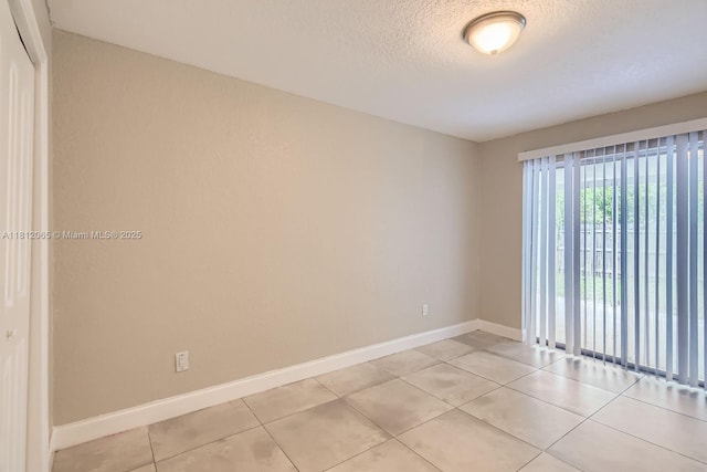9353 SW 1st Pl, Boca Raton, FL 33428 - unfurnished room featuring baseboards, light tile patterned floors, and a textured ceiling