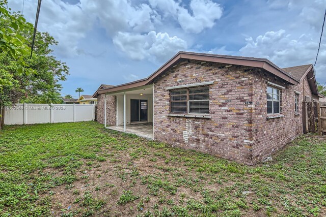 9353 SW 1st Pl, Boca Raton, FL 33428 - back of house featuring brick siding and a patio