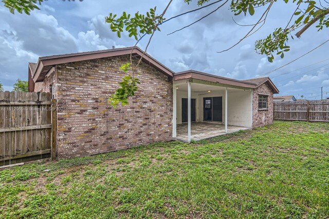 9353 SW 1st Pl, Boca Raton, FL 33428 - rear view of house featuring a patio area and brick siding
