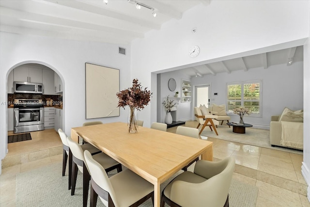 8538 NE 4th Ave, El Portal, FL 33138 - dining area featuring arched walkways, track lighting, and light tile patterned floors