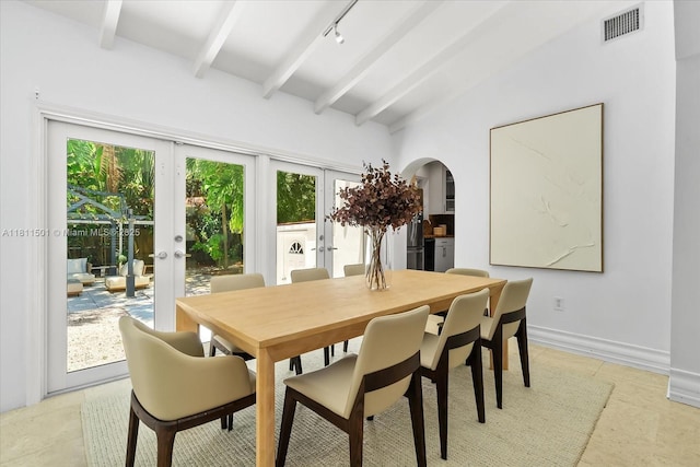 8538 NE 4th Ave, El Portal, FL 33138 - dining area featuring arched walkways, french doors, beamed ceiling, rail lighting, and baseboards