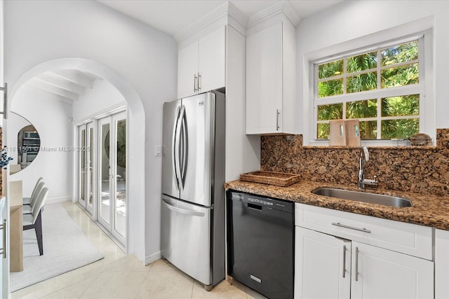 8538 NE 4th Ave, El Portal, FL 33138 - kitchen featuring black dishwasher, freestanding refrigerator, a sink, backsplash, and dark stone countertops