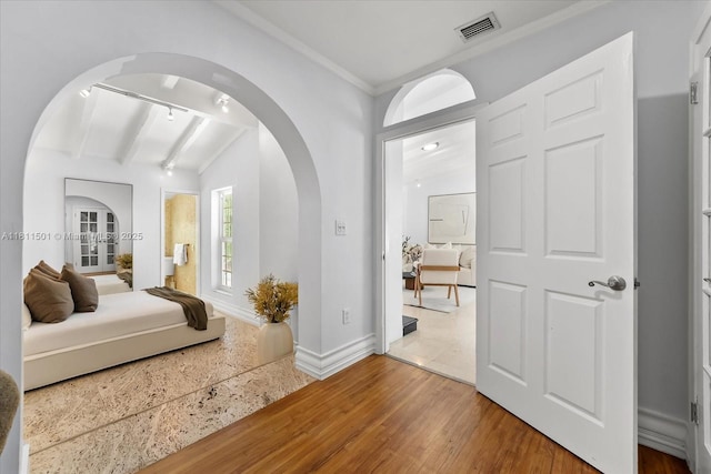 8538 NE 4th Ave, El Portal, FL 33138 - bedroom with arched walkways, wood finished floors, beam ceiling, baseboards, and crown molding