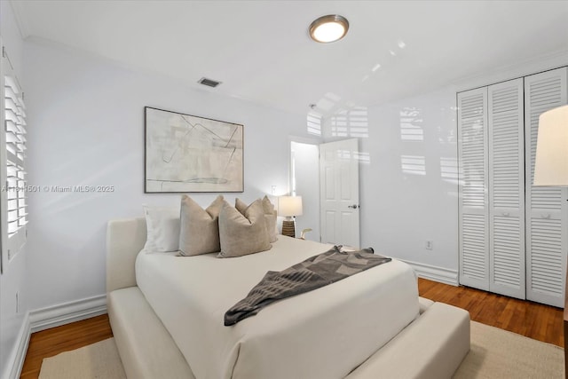 8538 NE 4th Ave, El Portal, FL 33138 - bedroom featuring wood finished floors, a closet, and baseboards