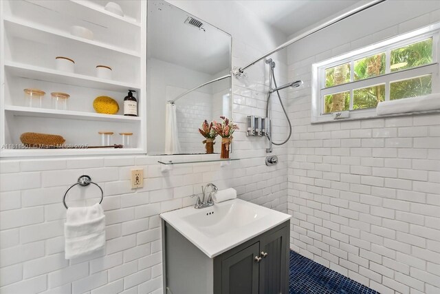 8538 NE 4th Ave, El Portal, FL 33138 - bathroom with vanity, tiled shower, and tile walls
