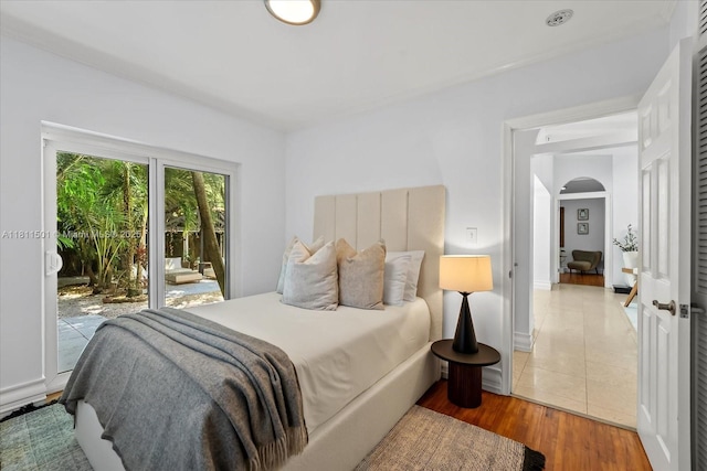 8538 NE 4th Ave, El Portal, FL 33138 - bedroom featuring access to outside, arched walkways, and wood finished floors
