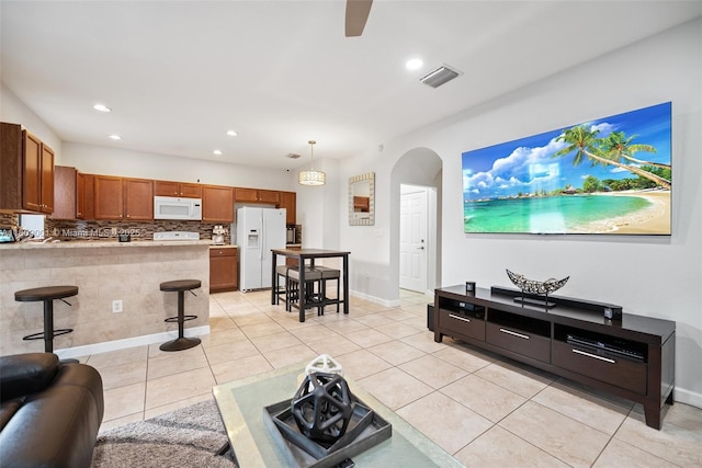 23900 SW 118th Ave, Homestead, FL 33032 - living area featuring light tile patterned flooring, arched walkways, recessed lighting, ceiling fan, and baseboards