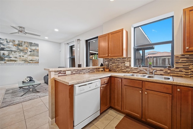 23900 SW 118th Ave, Homestead, FL 33032 - kitchen with dishwasher, a sink, a peninsula, tasteful backsplash, and light tile patterned flooring
