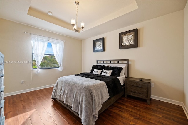 23900 SW 118th Ave, Homestead, FL 33032 - bedroom featuring dark wood-style flooring, a chandelier, baseboards, and a tray ceiling
