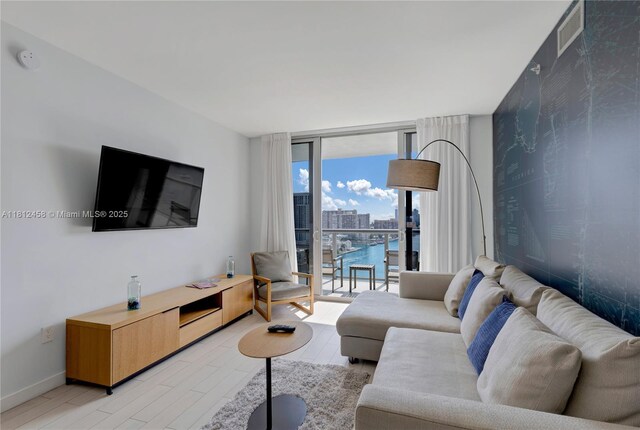 2602 E Hallandale Beach Blvd Unit R1709, Hallandale Beach, FL 33009 - living area featuring floor to ceiling windows, light wood-type flooring, baseboards, and wallpapered walls