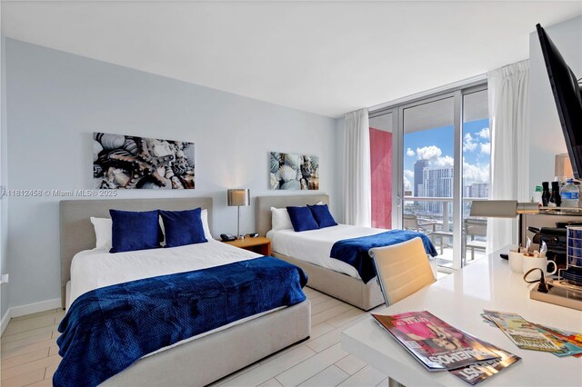 2602 E Hallandale Beach Blvd Unit R1709, Hallandale Beach, FL 33009 - bedroom featuring a wall of windows and access to outside