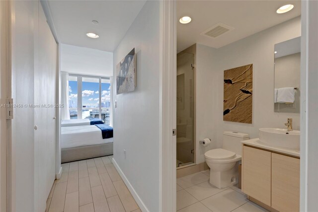 2602 E Hallandale Beach Blvd Unit R1709, Hallandale Beach, FL 33009 - ensuite bathroom featuring a shower stall, toilet, vanity, tile patterned flooring, and recessed lighting