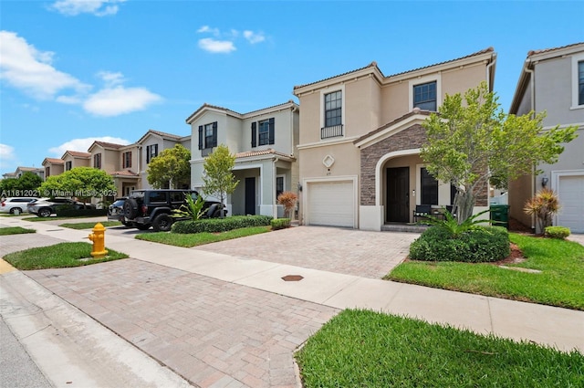 659 NE 191st St, Miami, FL 33179 - view of front facade with stucco siding, decorative driveway, stone siding, a residential view, and a garage