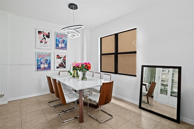 659 NE 191st St, Miami, FL 33179 - tiled dining space featuring a chandelier and baseboards