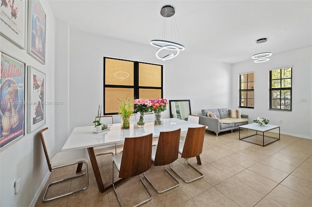659 NE 191st St, Miami, FL 33179 - dining area featuring baseboards, light tile patterned floors, and a chandelier