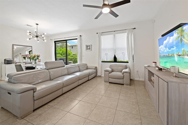 659 NE 191st St, Miami, FL 33179 - living area with light tile patterned flooring, a chandelier, and ceiling fan