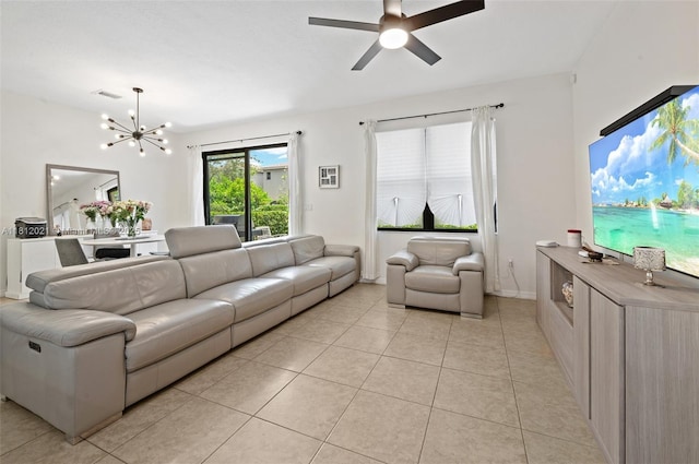 659 NE 191st St, Miami, FL 33179 - living room with light tile patterned floors, a ceiling fan, and a chandelier