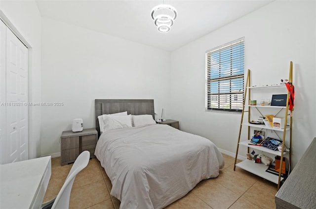 659 NE 191st St, Miami, FL 33179 - bedroom featuring light tile patterned floors and baseboards