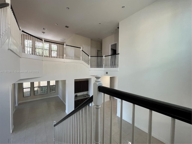 8248 Lost Creek Ln, Delray Beach, FL 33446 - staircase with a towering ceiling, baseboards, and tile patterned floors