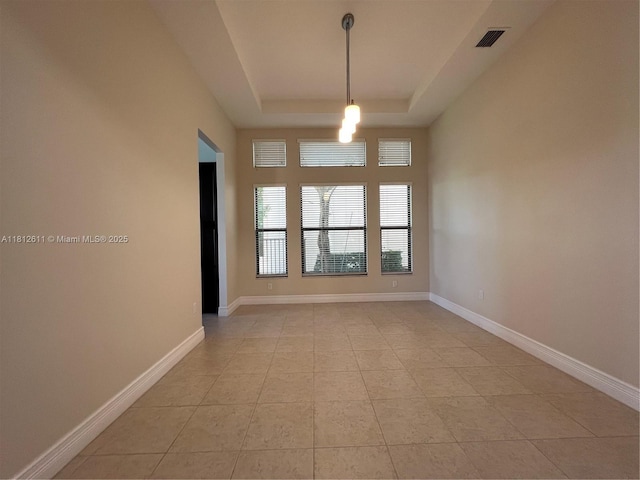 8248 Lost Creek Ln, Delray Beach, FL 33446 - empty room featuring a tray ceiling, light tile patterned flooring, and baseboards