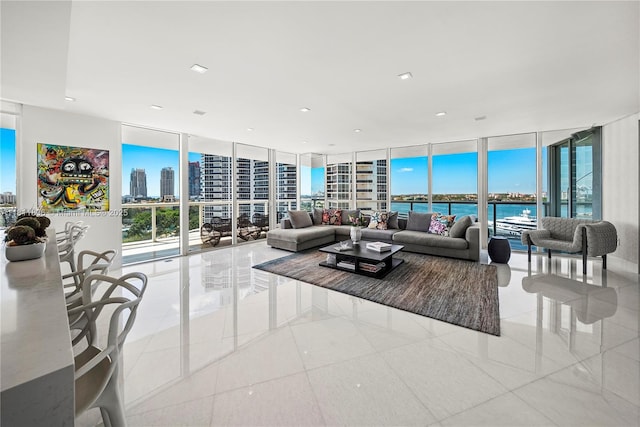 450 Alton Rd Unit 1007, Miami Beach, FL 33139 - tiled living room with floor to ceiling windows, a view of city, and a water view