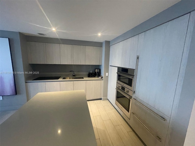 4010 S Ocean Dr Unit R1705, Hollywood, FL 33019 - kitchen with oven, modern cabinets, a sink, light wood-type flooring, and recessed lighting